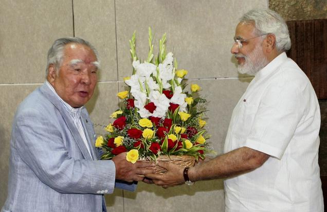 Osamu Suzuki, left, chairman of Suzuki Motors, greeting Narendra Modi, chief minister of the state of Gujarat